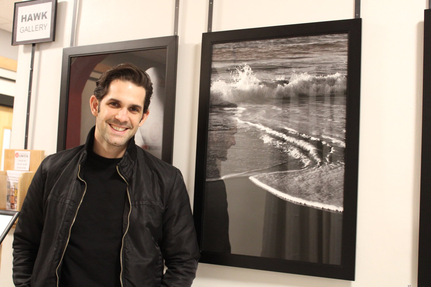 Lucas Hoeffel with a photograph of the shore at Fort Tilden, NY.